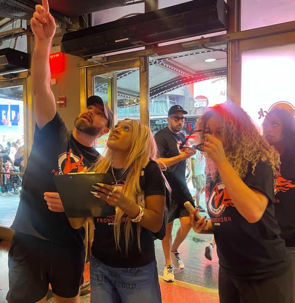 Team solving clues inside Hard Rock Cafe during a Times Square NYC scavenger hunt