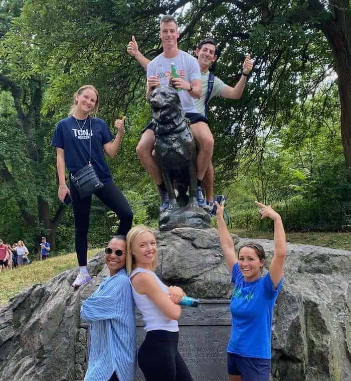 Corporate team building group at the Balto statue during a Central Park scavenger hunt in NYC